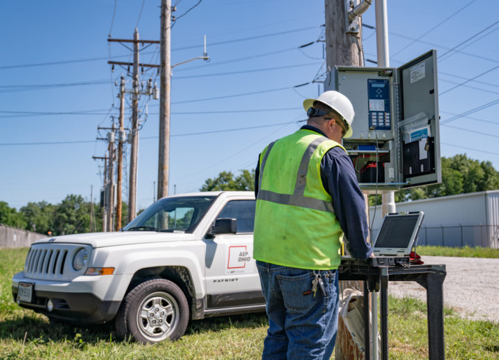 AEP Ohio crew member standing outside, installing smart technology on equipment.