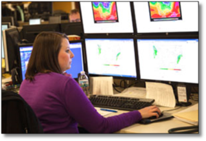 Megan Klee in the storm center, watching storms on four large screens