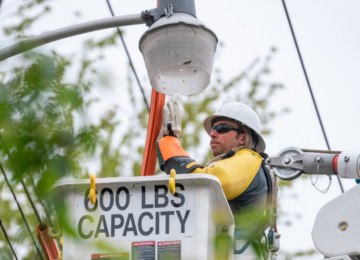 A lineworker in a bucket. In-action on the job.