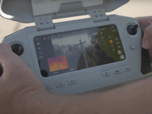 Controller of drone showing both detailed and infrared imagery.