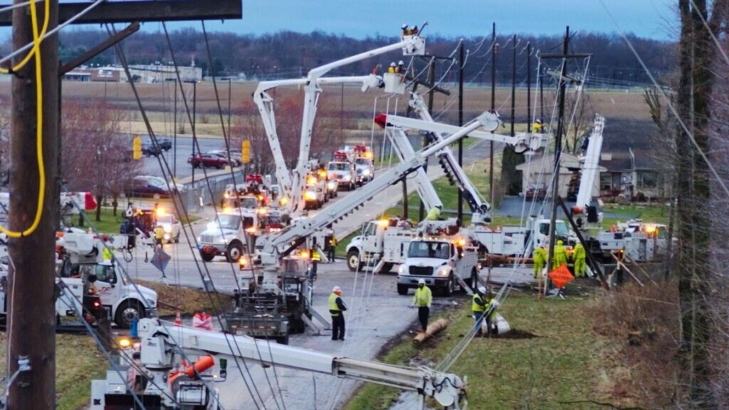 A photo of multiple crews working to restore power after a severe windstorm in March 2026.