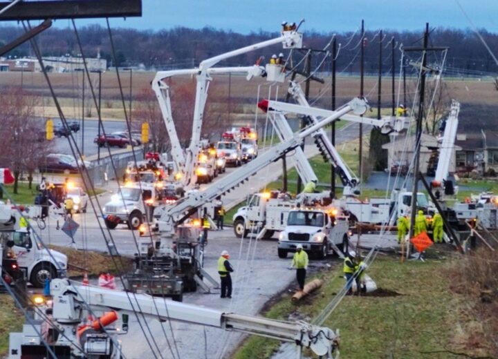 A photo of multiple crews working to restore power after a severe windstorm in March 2026.